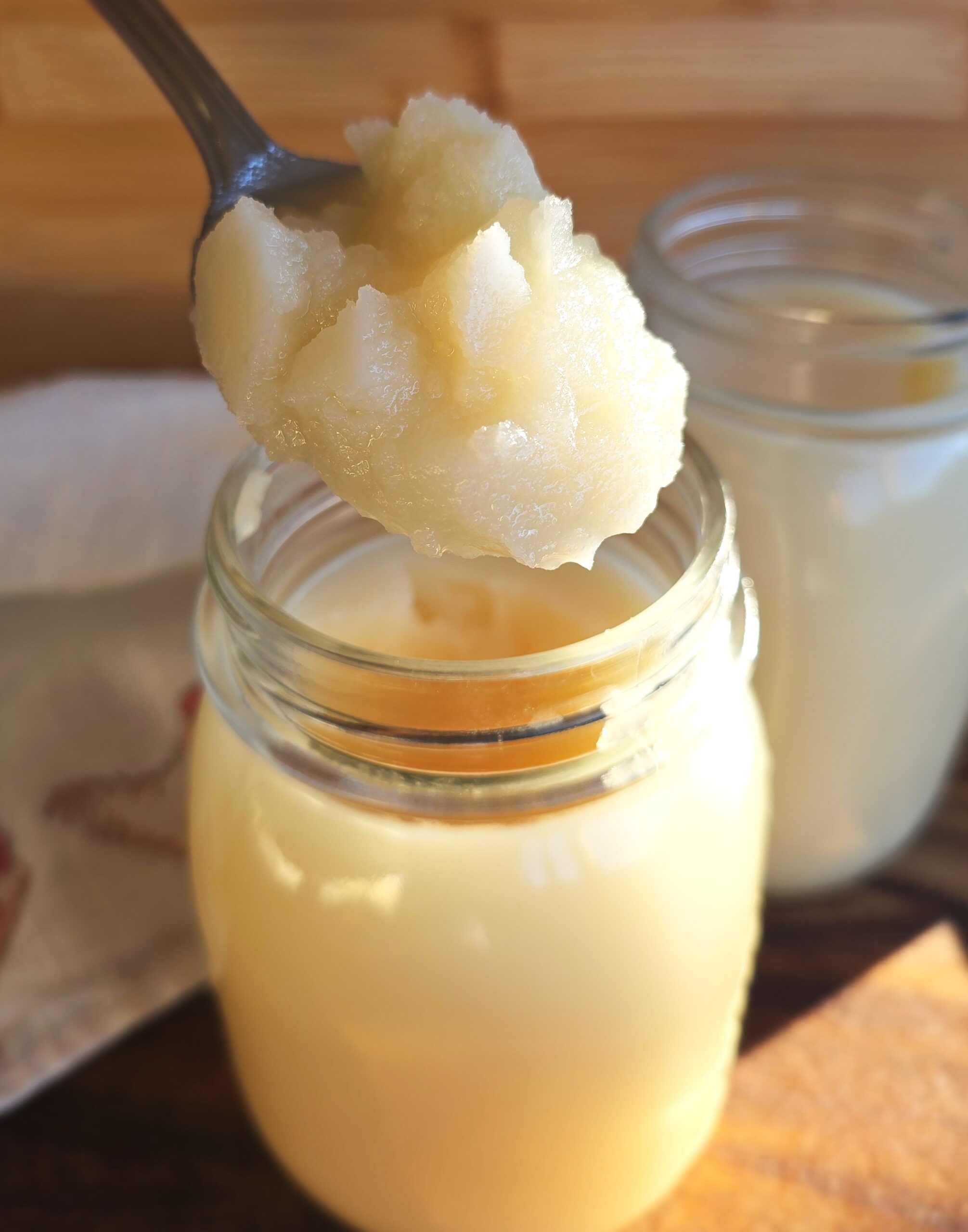 Jar of rendered, clairified, purified, homemade grass fed beef tallow showing the creamy consistency and white colour 